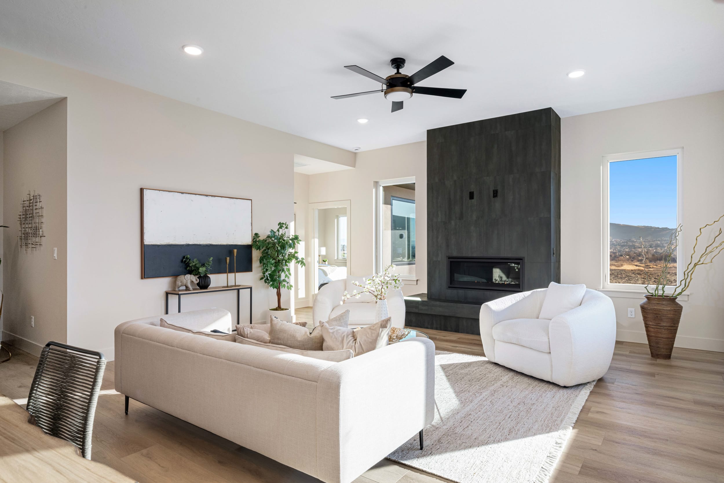 Modern living room with fireplace and natural light.