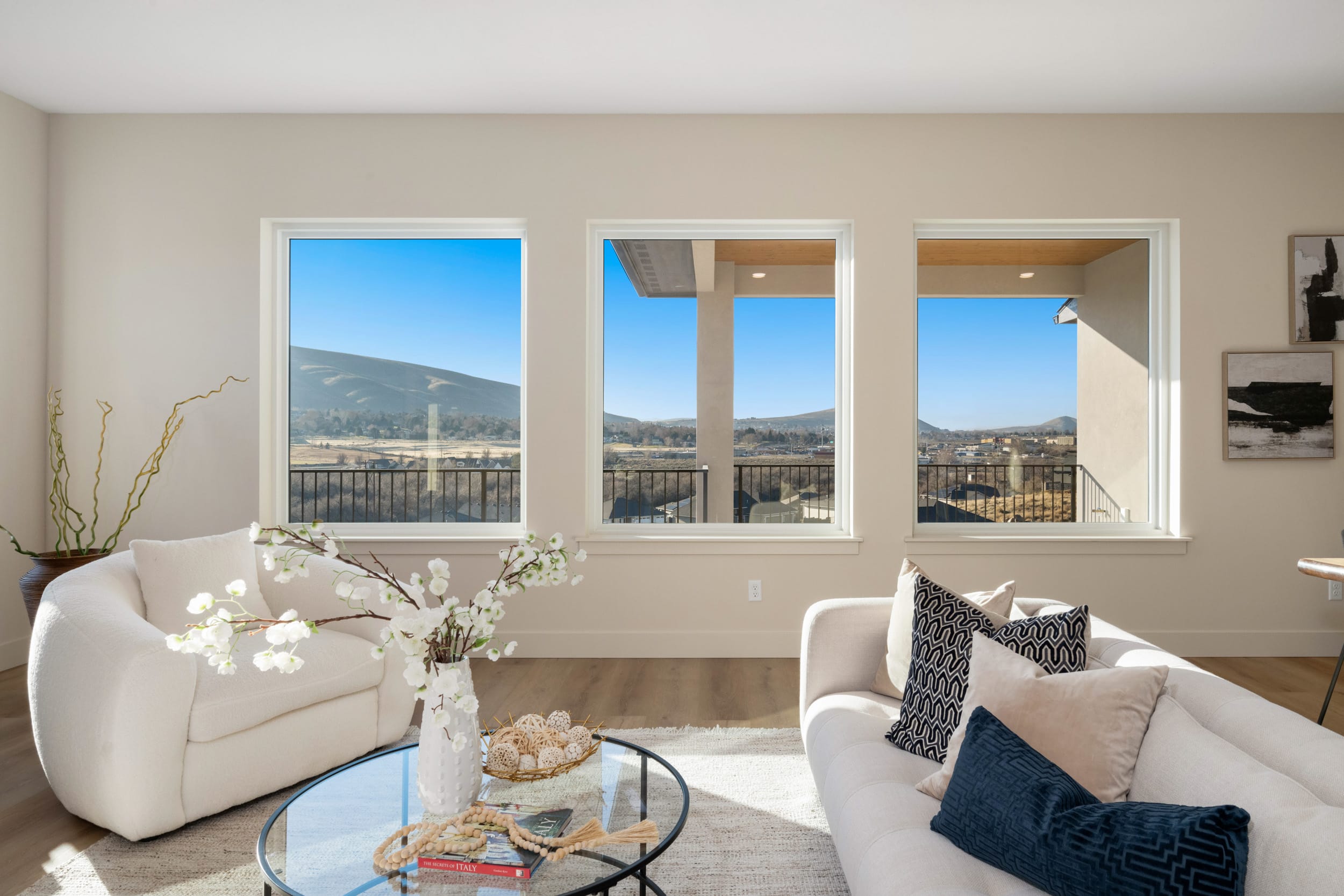 Living room with mountain view through windows.