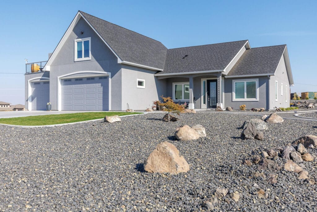 Modern house with gravel landscape and garage