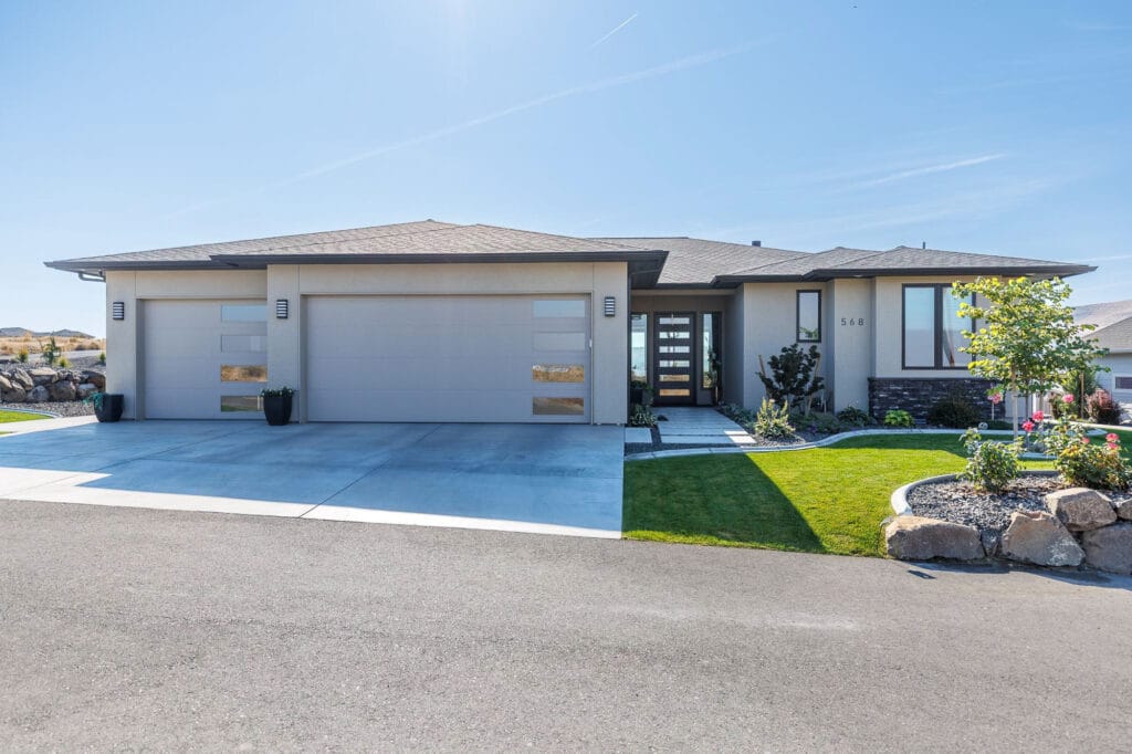 Modern suburban house with landscaped front yard.